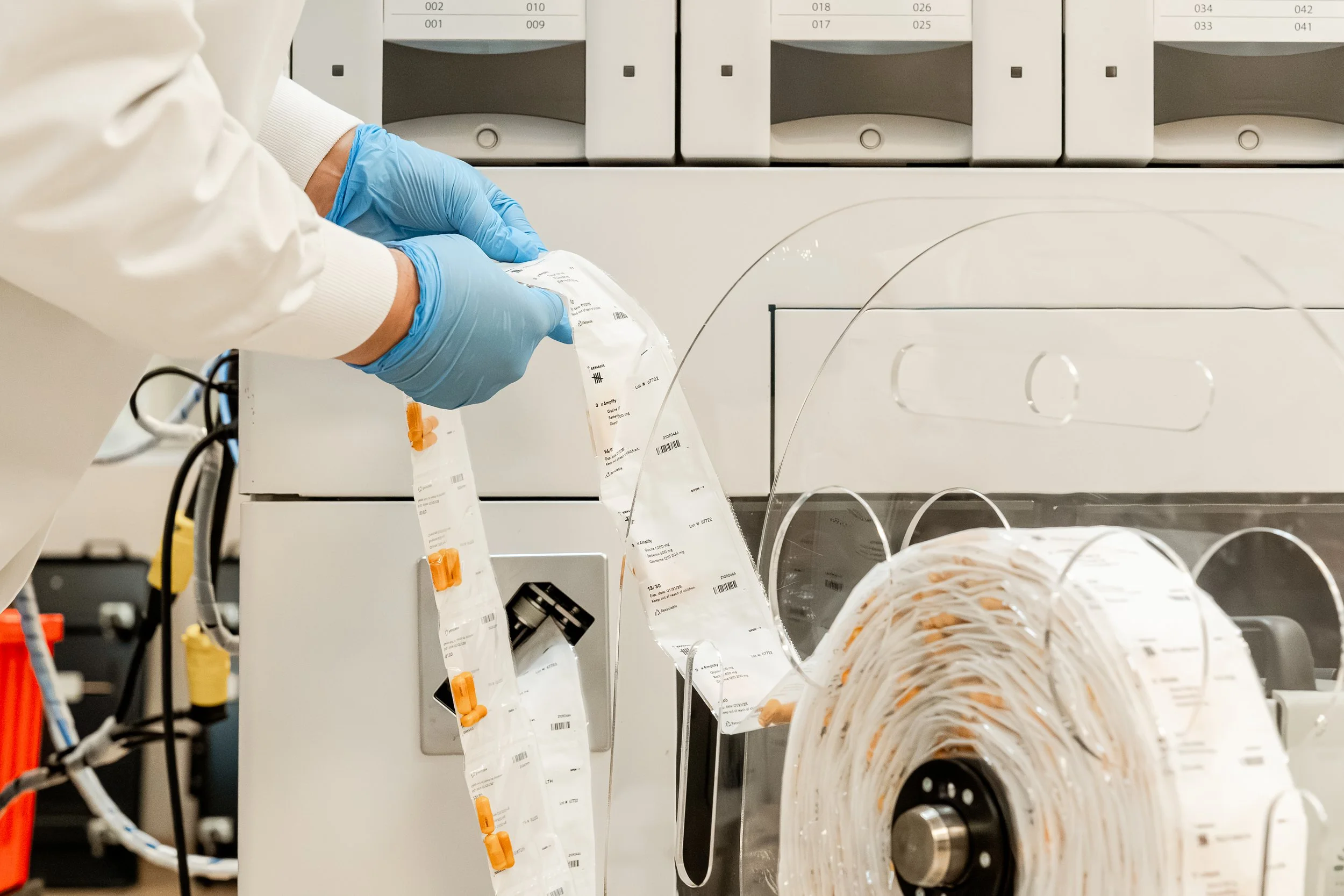Daily supplement pouches moving through an automated production line